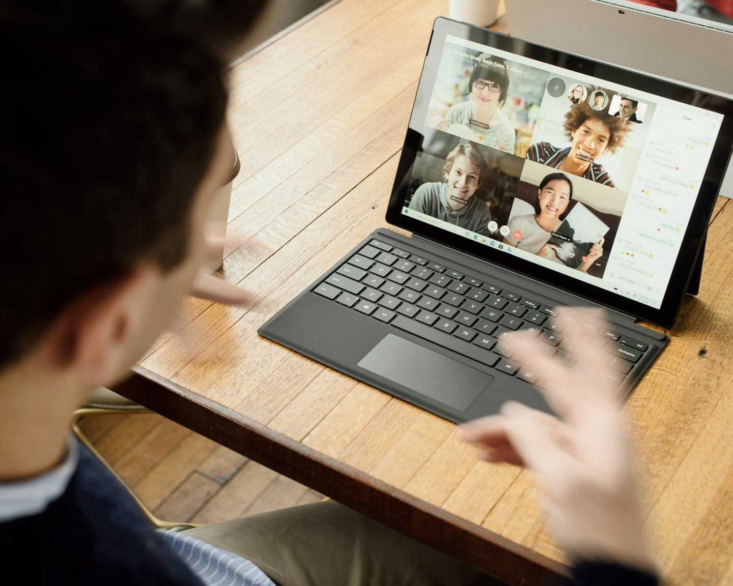 Person using a laptop for a video conference call.