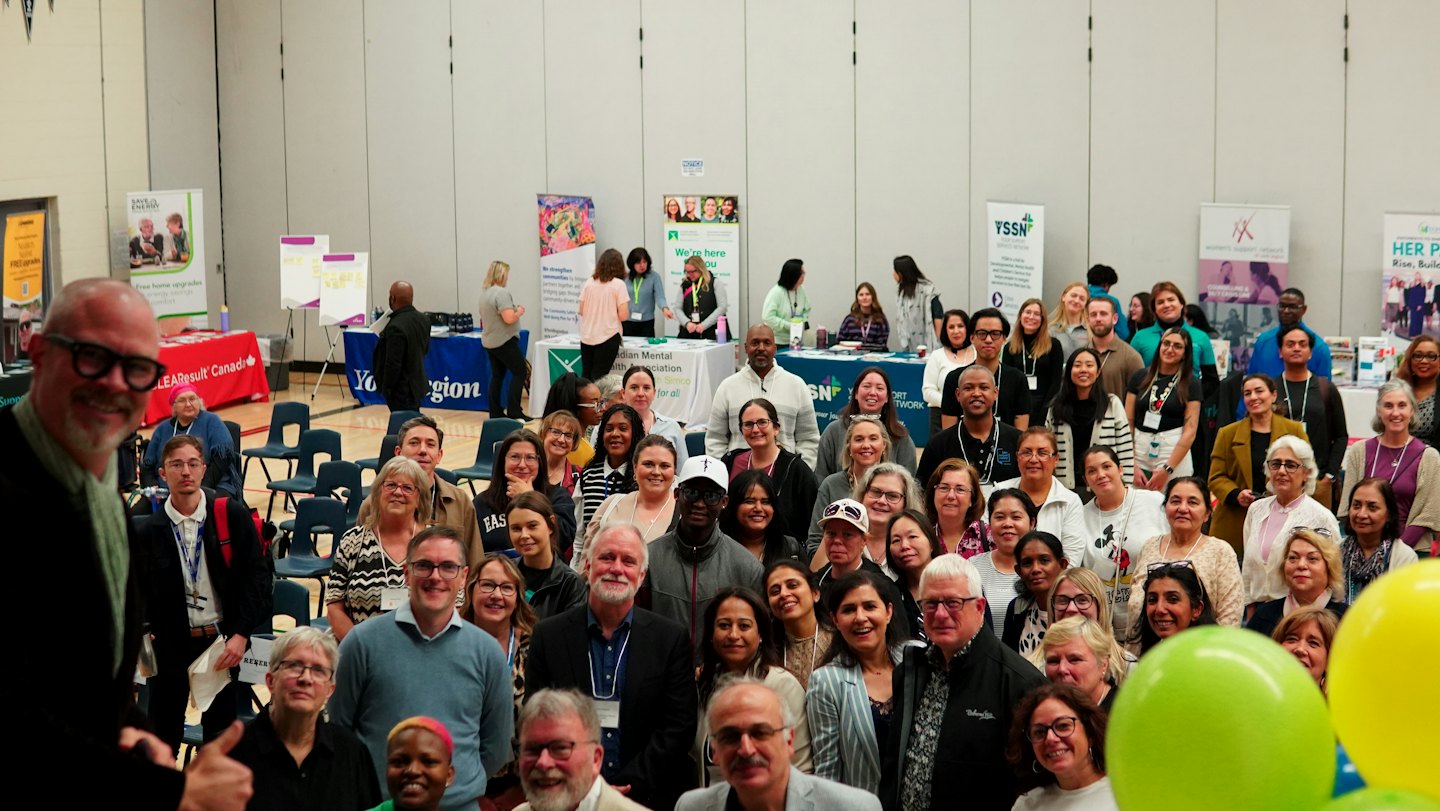 A diverse group of people gather together at a community event.