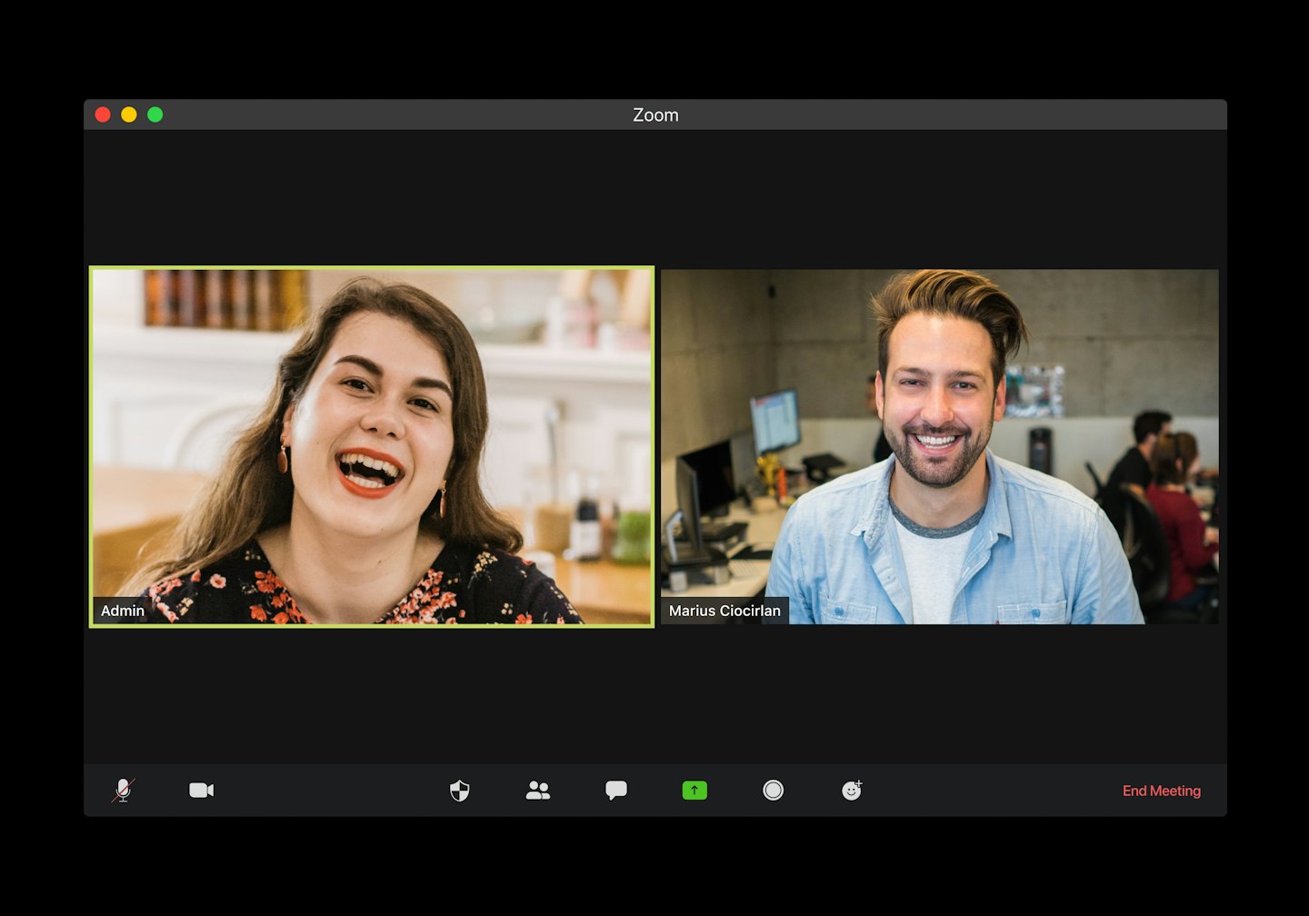 Two people smiling during a video conference call.